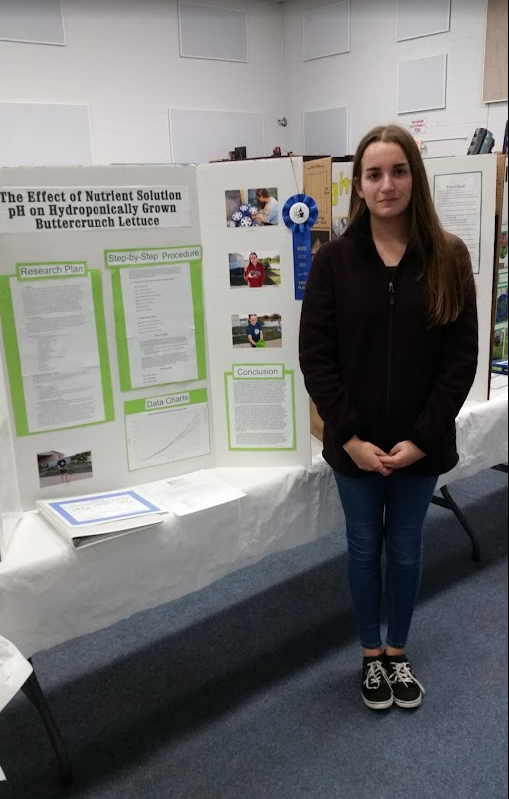 Rebecca Perkins with her blue-ribbon science fair project on the effect of nutrient solution pH on hydroponically grown buttercrunch lettuce